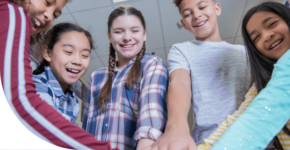 teenage boys and girls smiling and holding hands