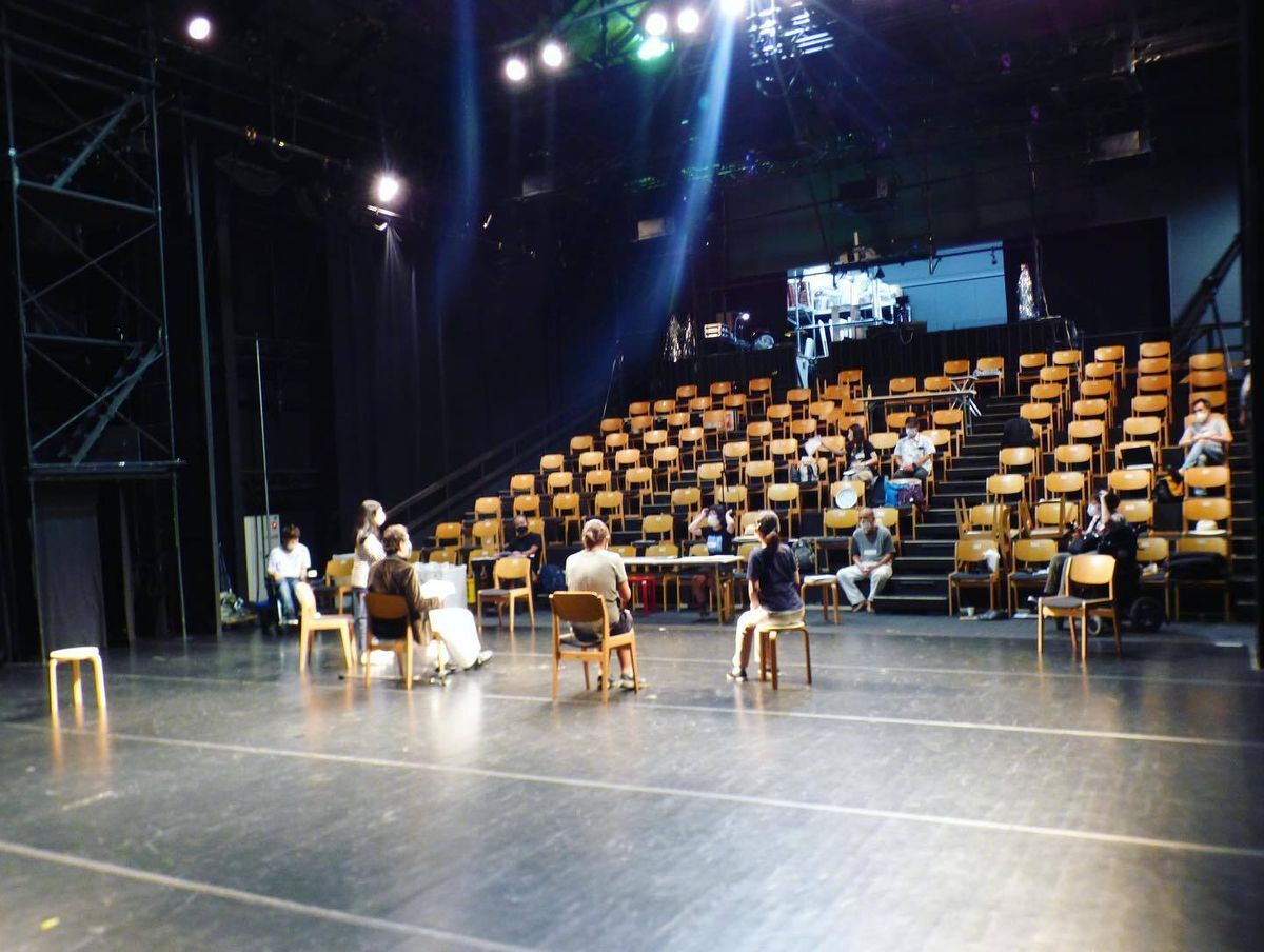 A picture of the BIRD Theatre with people sitting in the audience who are rehearsing for the plays