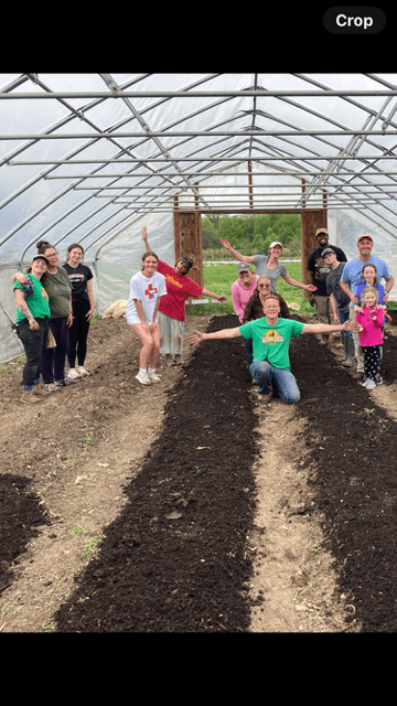 Man in a flannel shirt hugs his daughter to his slide.