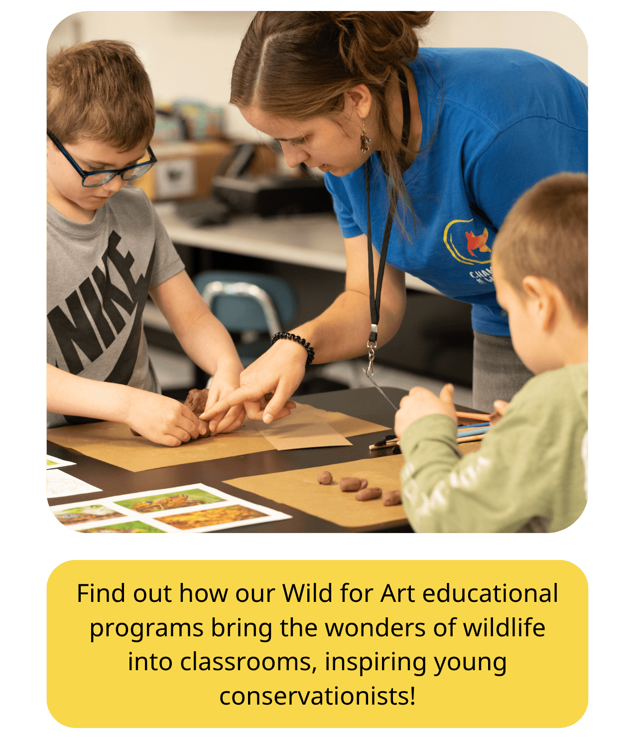 Education Coordinator helps students sculpt the American Red Wolf in clay