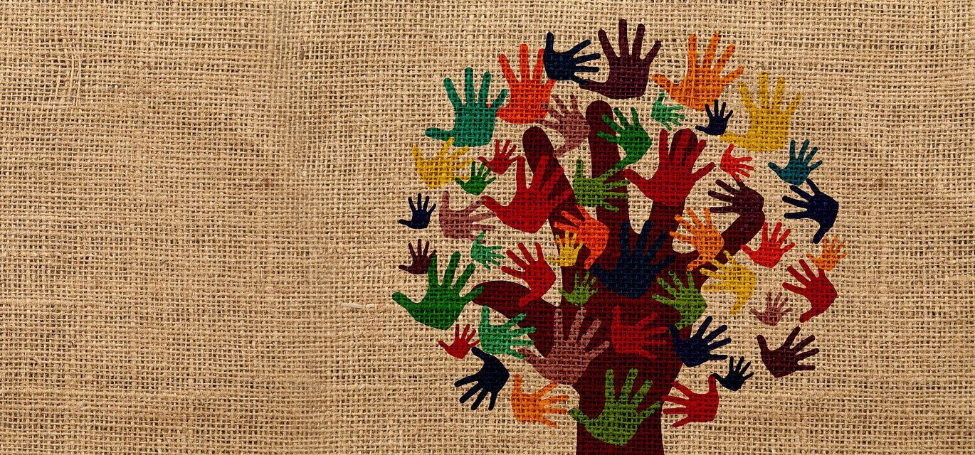 A tree made of colorful handprints on a burlap-textured background.