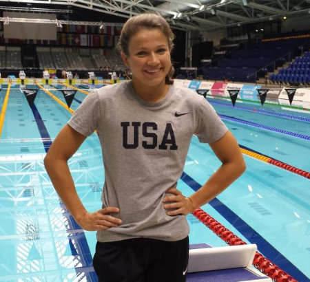 A picture of Becca Meyers in front of a pool wearing a USA shirt