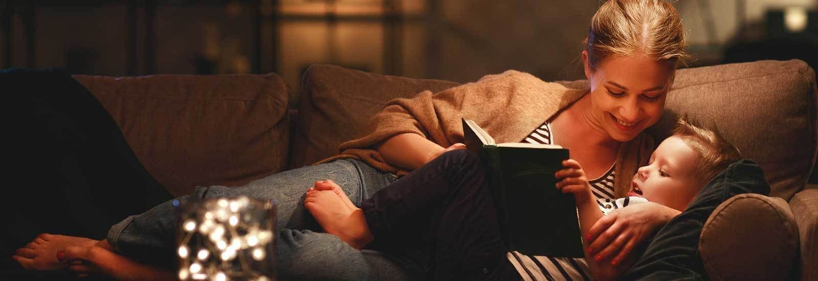 Mom and Son Reading on Couch