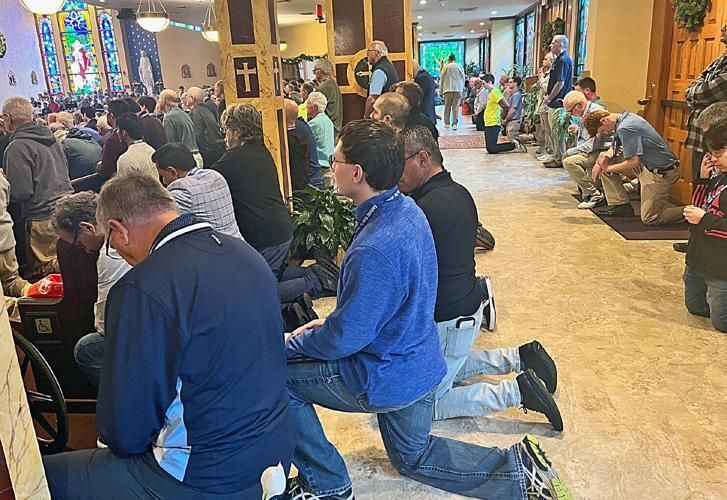 Attendees Kneeling at  Men's Rally