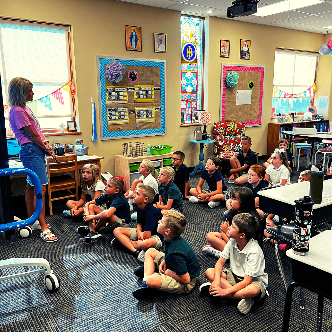 Bergan first grade students sitting on the floor looking and listening to the teacher. 