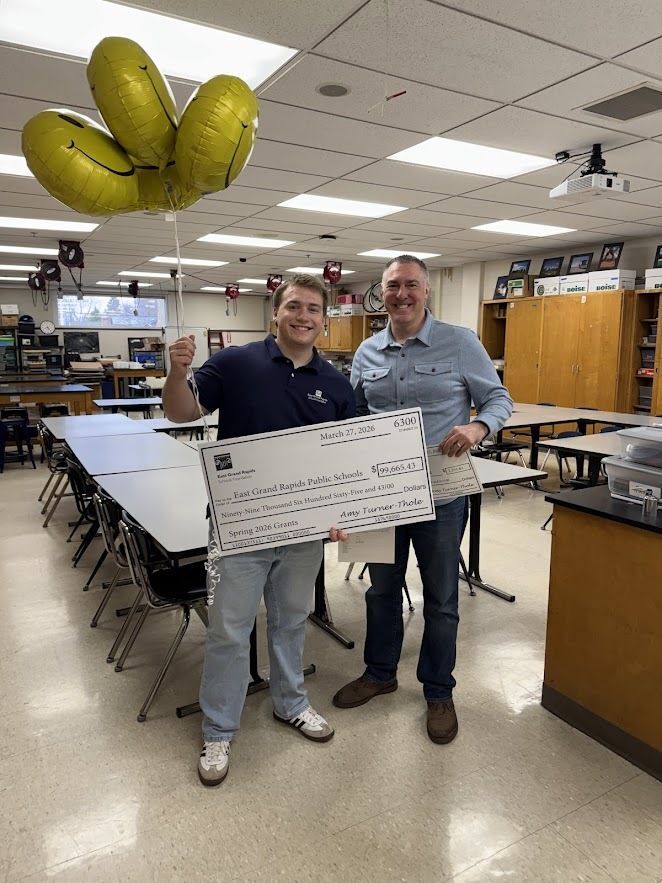 teacher and student standing with big check for Foundation grants