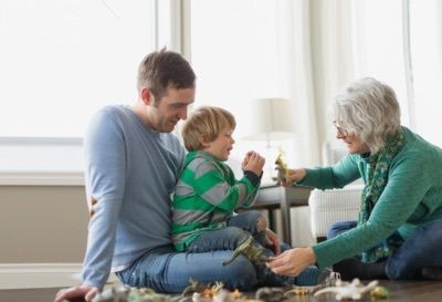 father, child and grandmother playing together