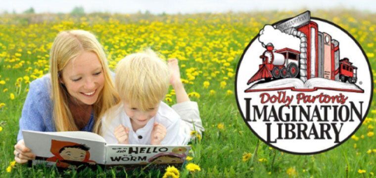 Mother and boy reading in a field