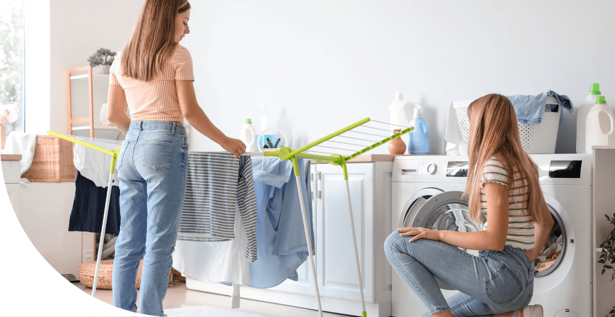 two girls doing laundry in a washing machine