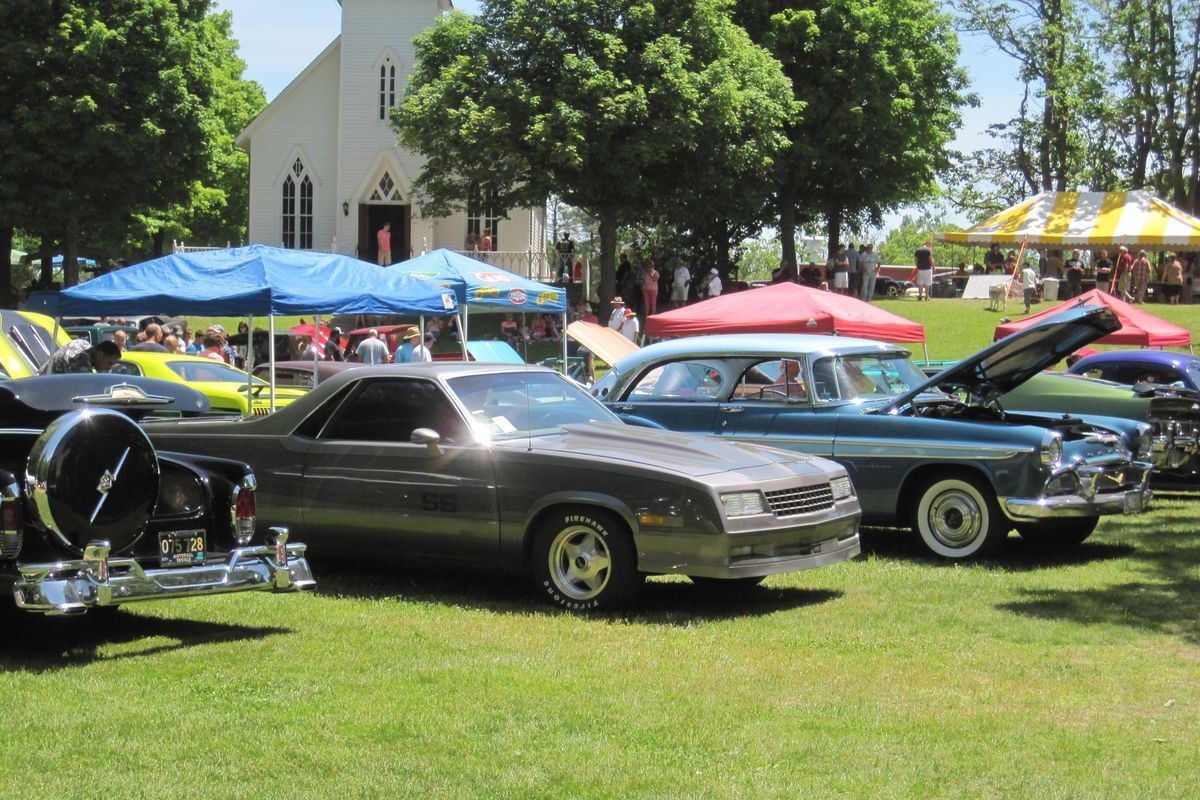 View of a field filled with classic cars.