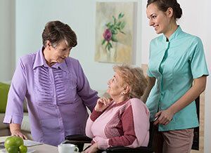 Elderly woman and two nurses.