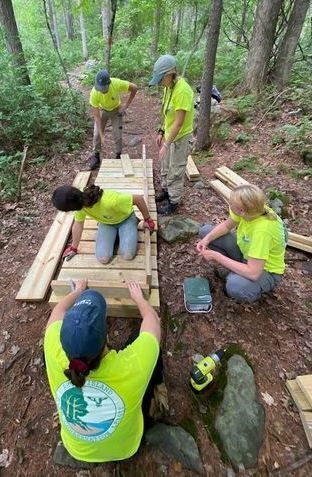 2022 YCL Members building a trail boardwalk