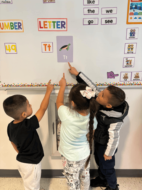 Elementary student engaging with interactive word wall.