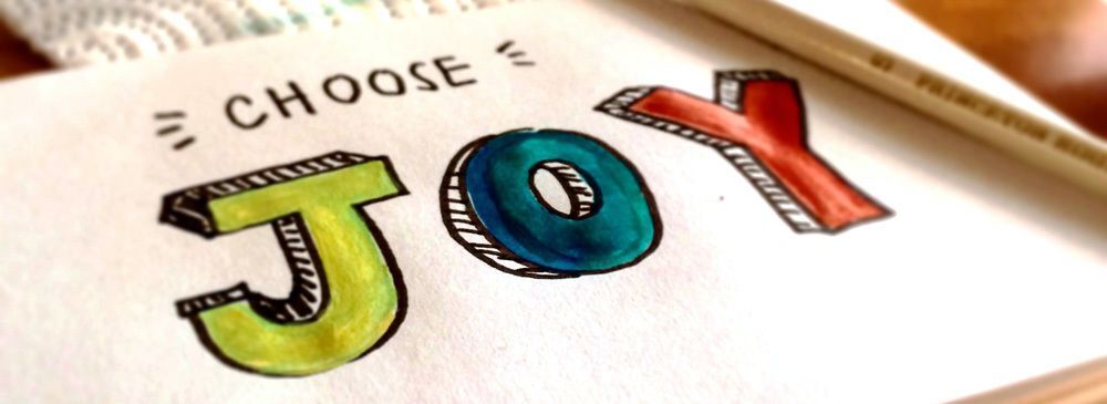 Photo of a piece of paper with "Choose JOY" written on it in colorful letters.