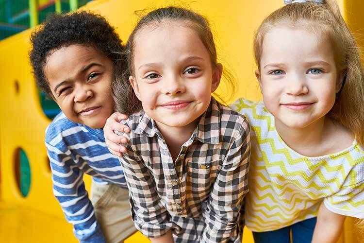 Three Children in Front of Bus