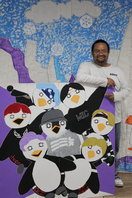 Tyler posing with BTS Penguins