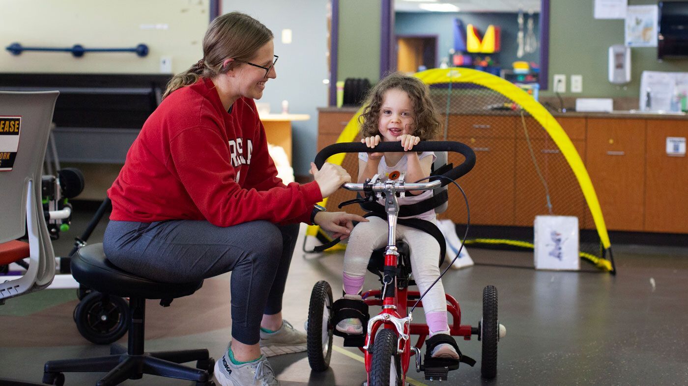 Staff and child in physical therapy session