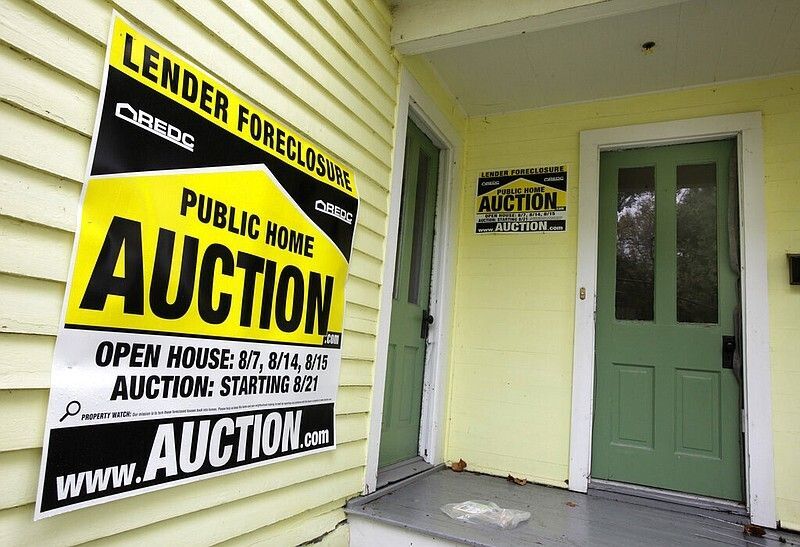 A home has a foreclosure auction sign displayed in this Sept. 22, 2010 file photo. (AP/Amy Sancetta)