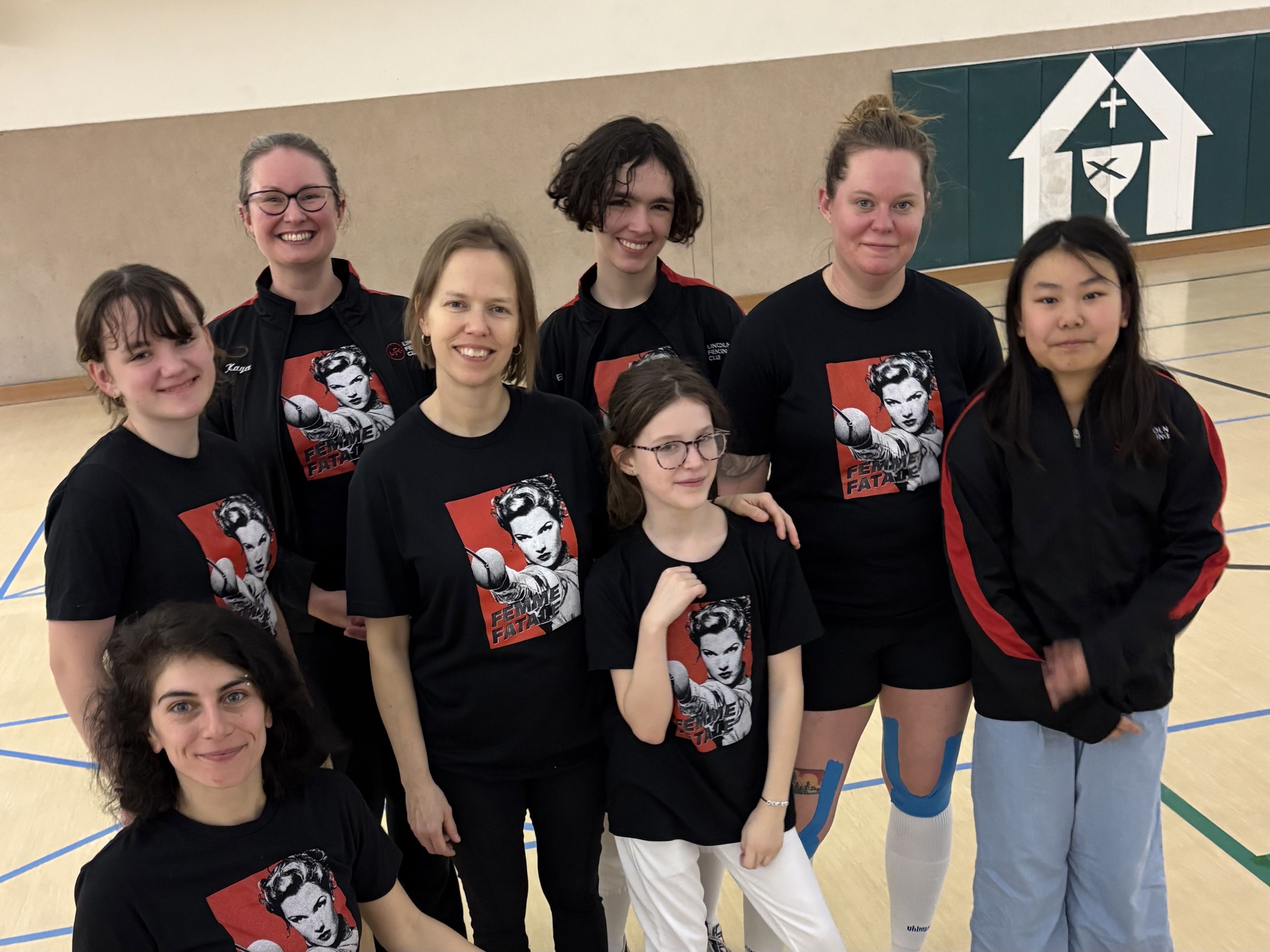 A group of female fencers pose for the camera