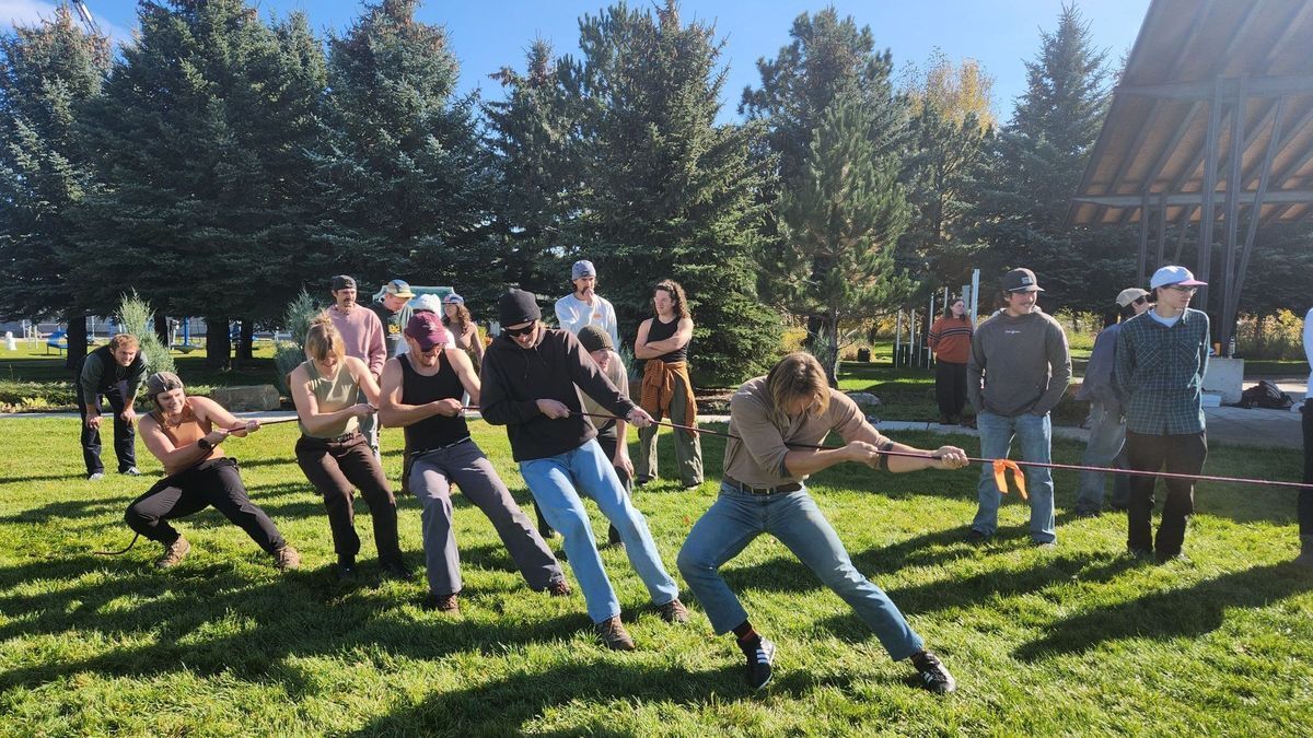 [Image Description: Greater Yellowstone crew members play tug of war at their crew member graduation.]