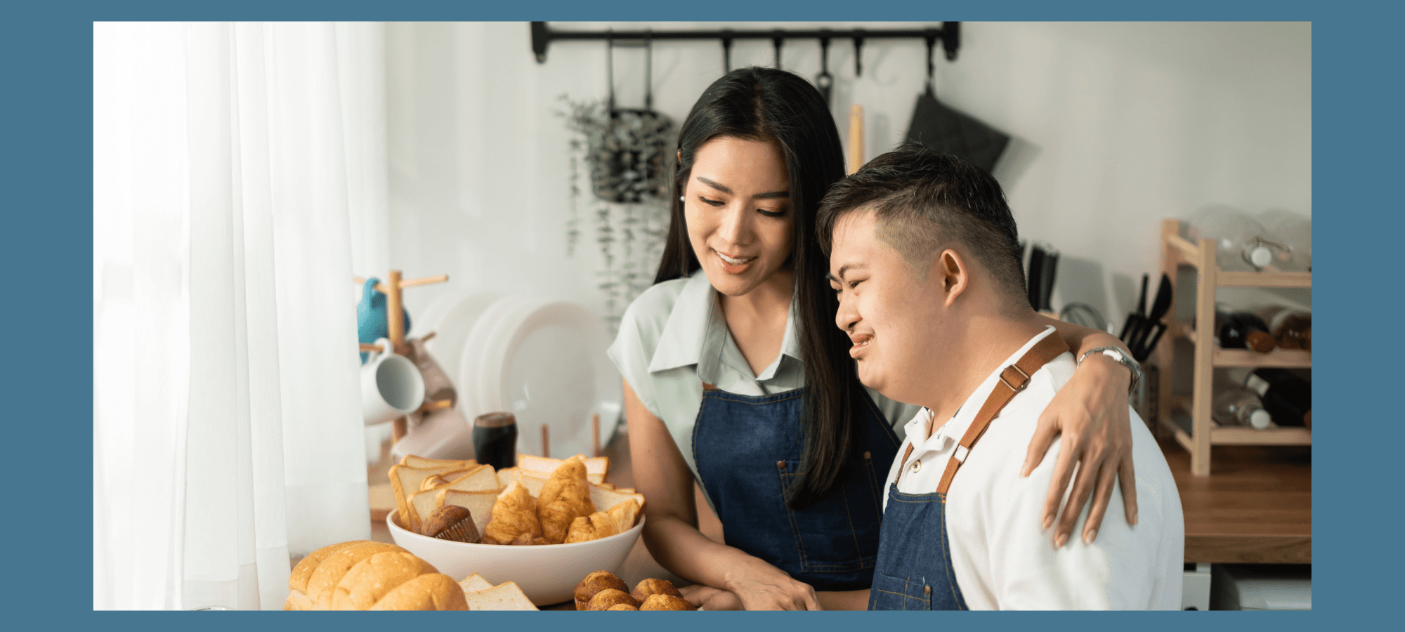 Woman with black hair has her arms around man with black hair as they are baking.