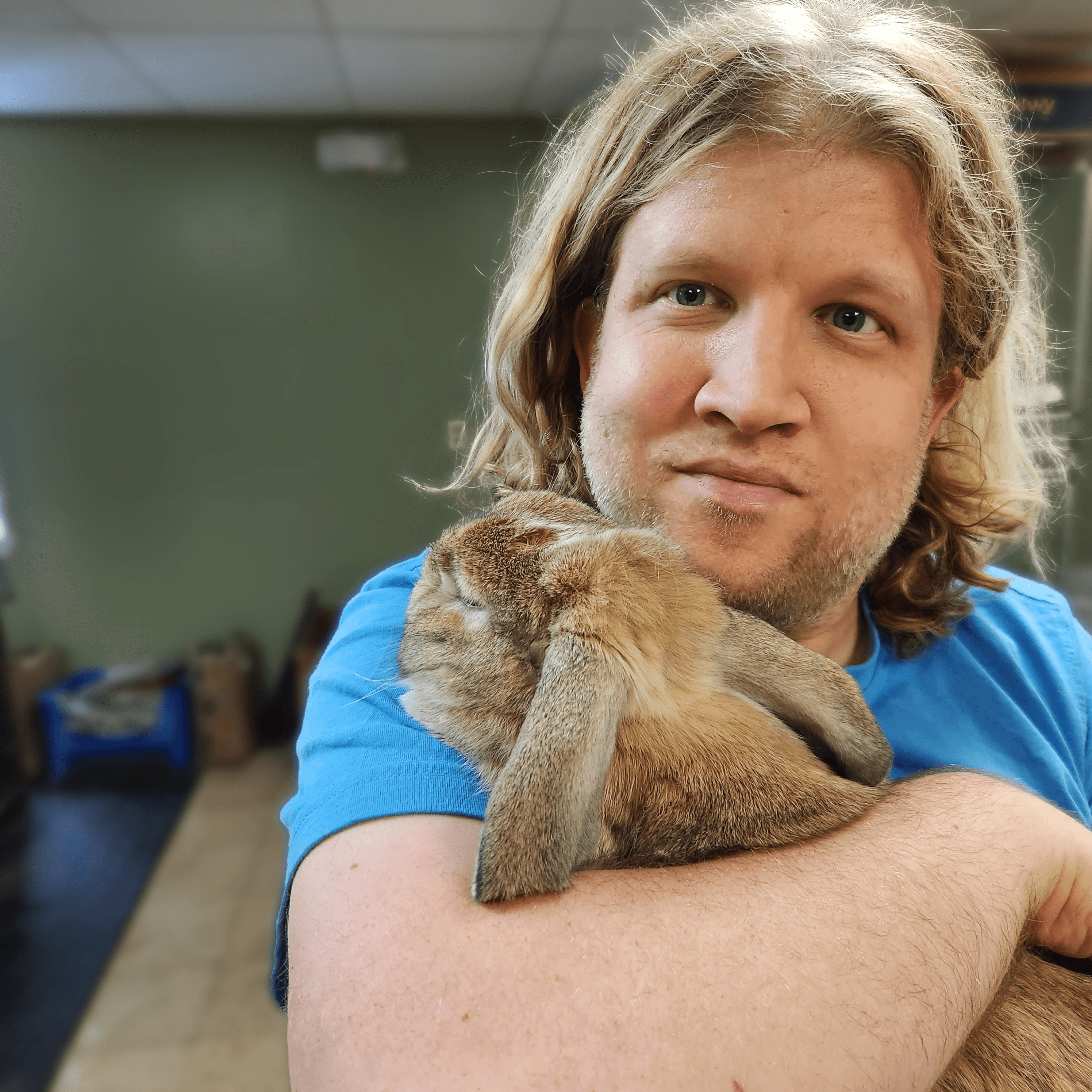 Program member Tim is hugging a rabbit