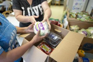 People packaging up food boxes.