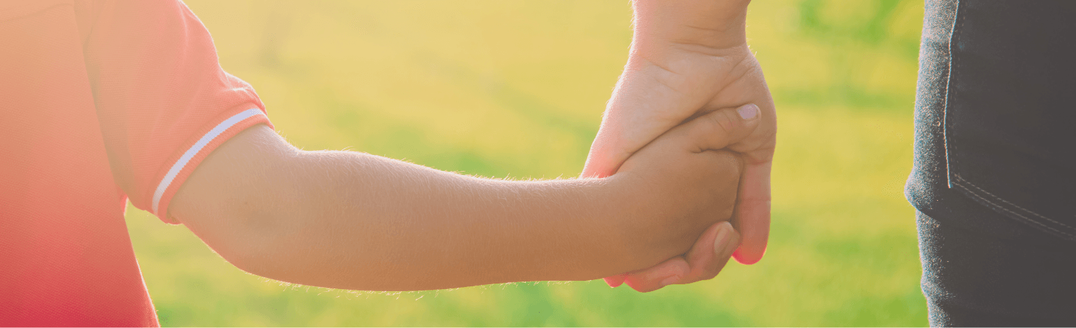 image of a boy holding his mom's hand