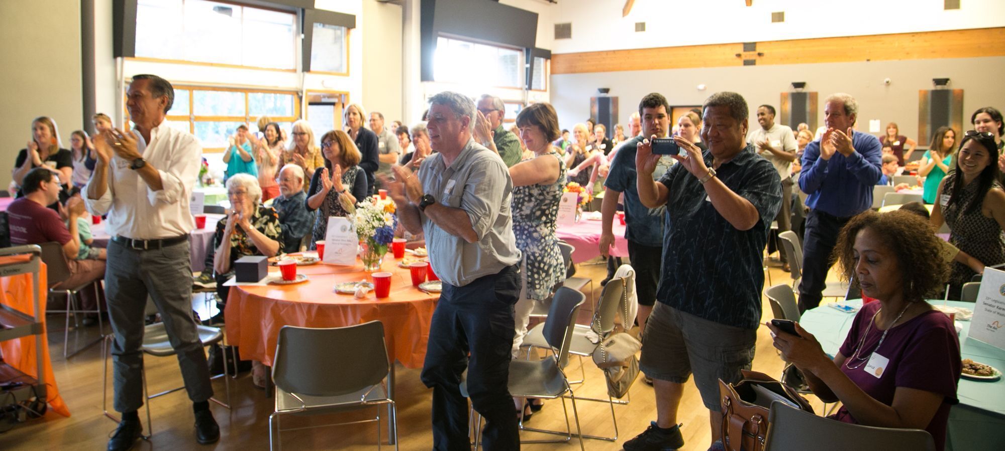 People clapping and smiling