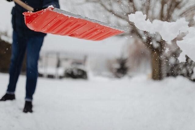 Indistinct person shoveling snow
