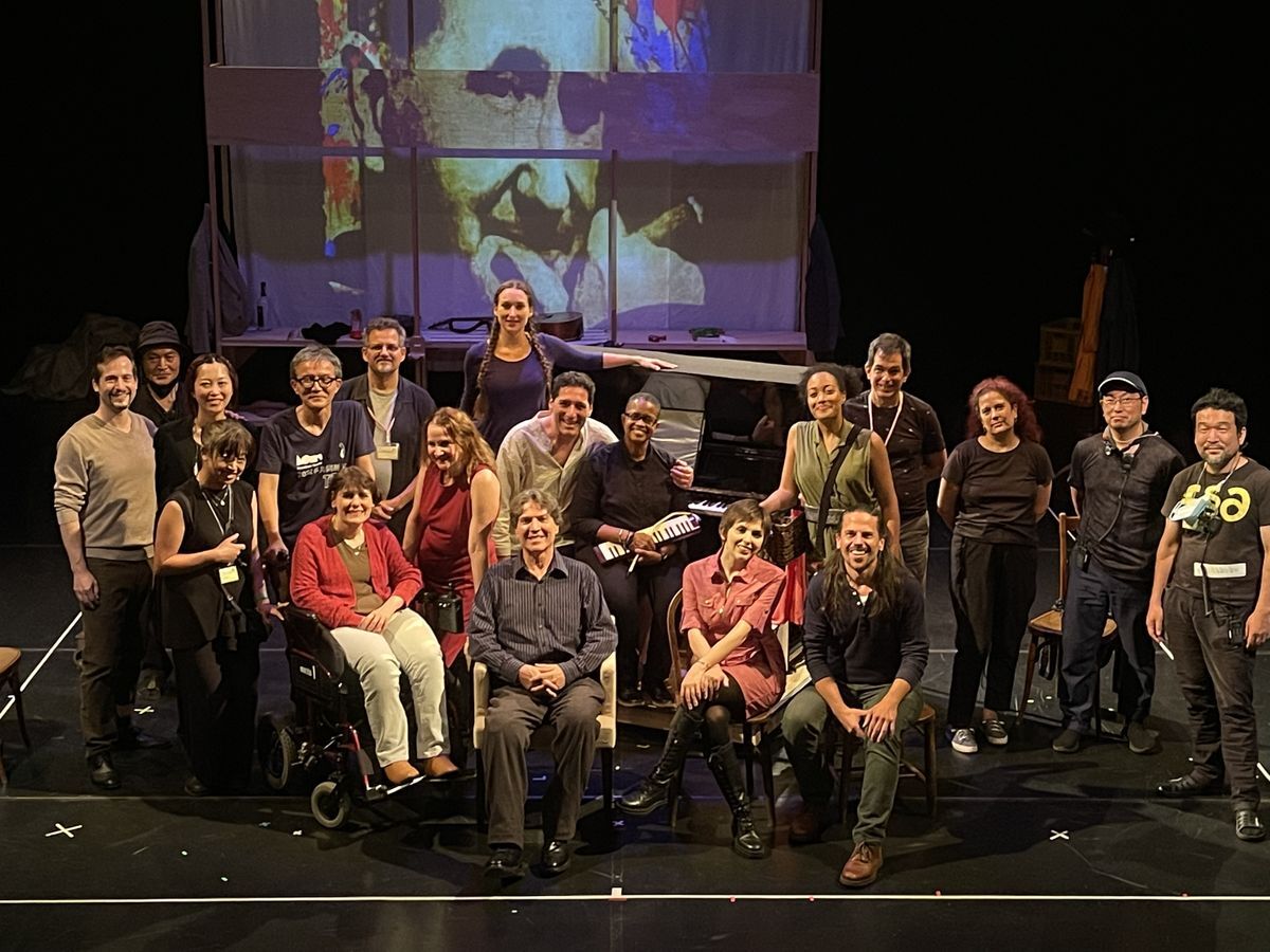 A picture of the cast and crew of Brecht on Brecht. They are all on a stage and both standing and sitting.