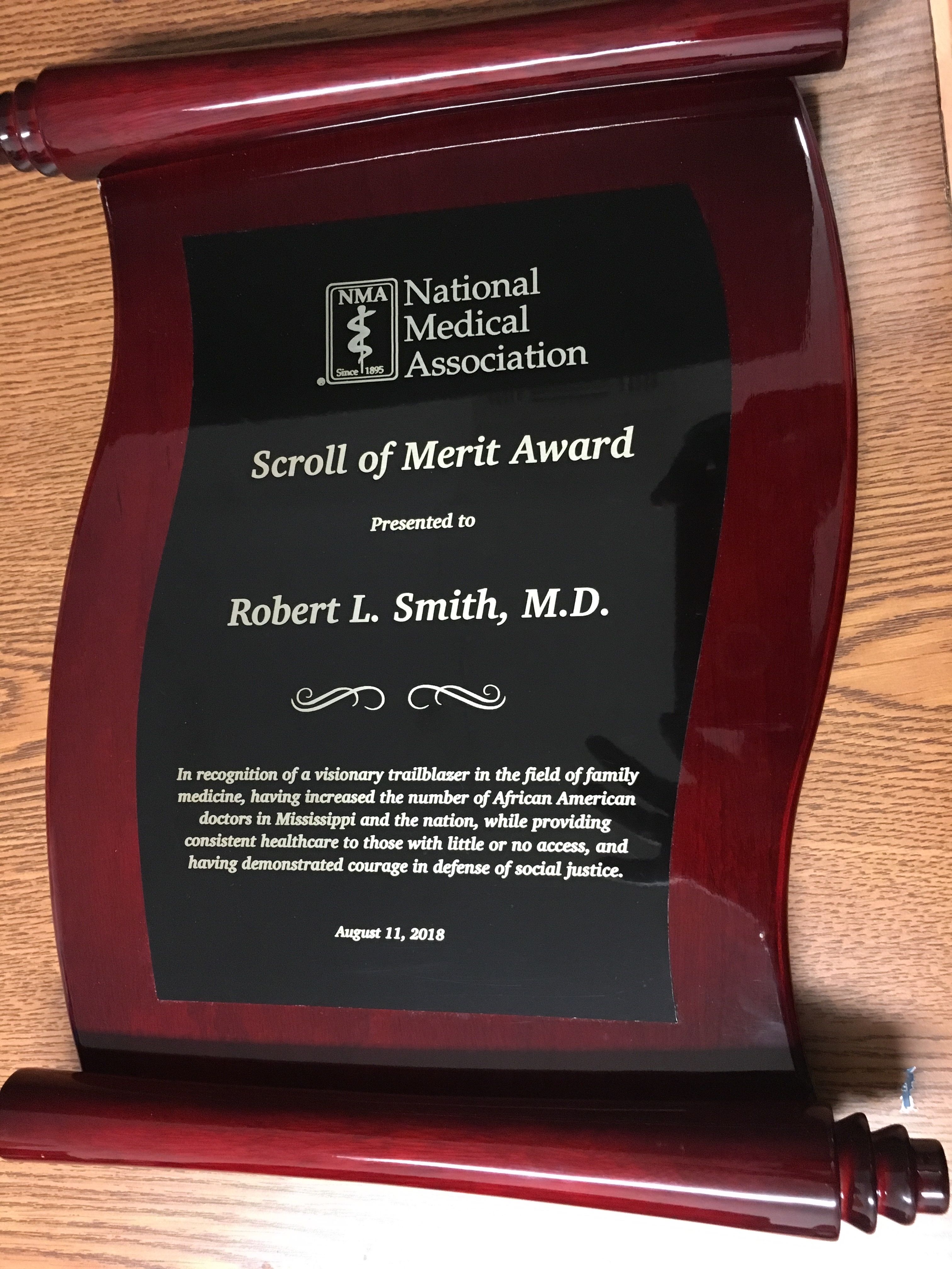 DR. ROBERT SMITH, CLASS OF 1961, RECEIVES NMA SCROLL OF MERIT AWARD.