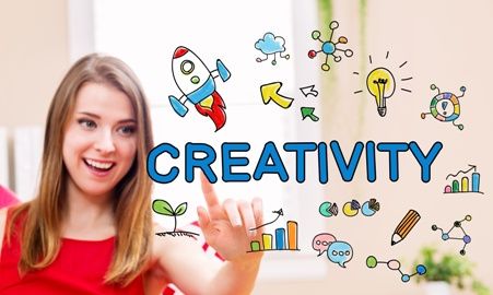 young woman pointing toward graphic reading "creativity" and surrounded by drawn graphics