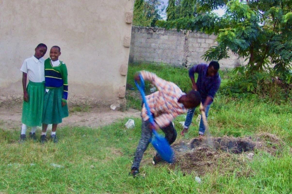 Students digging a hole.