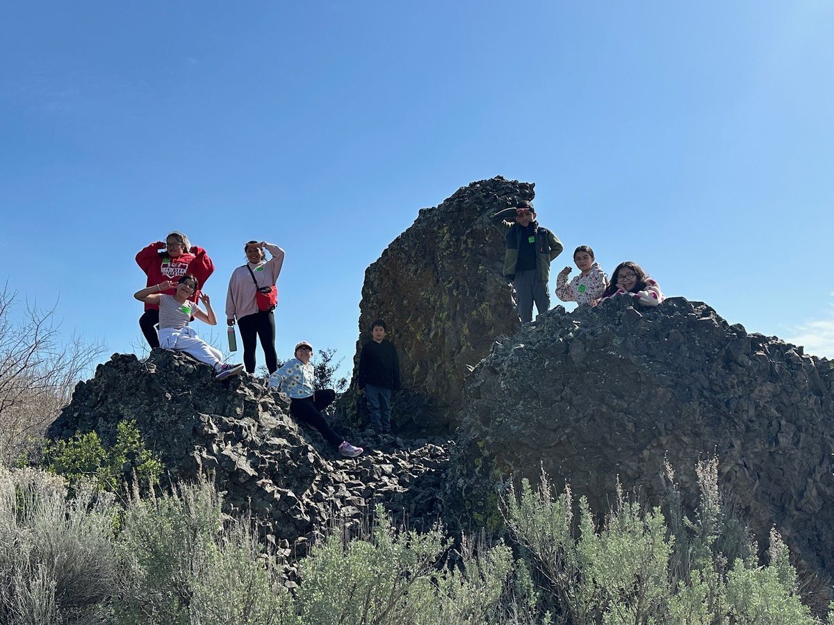 Students standing on a rock at Bridgeport State Park during a Field Day.