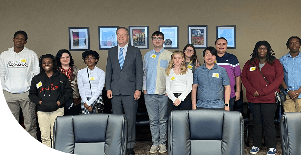 students standing with County Executive Sam Page