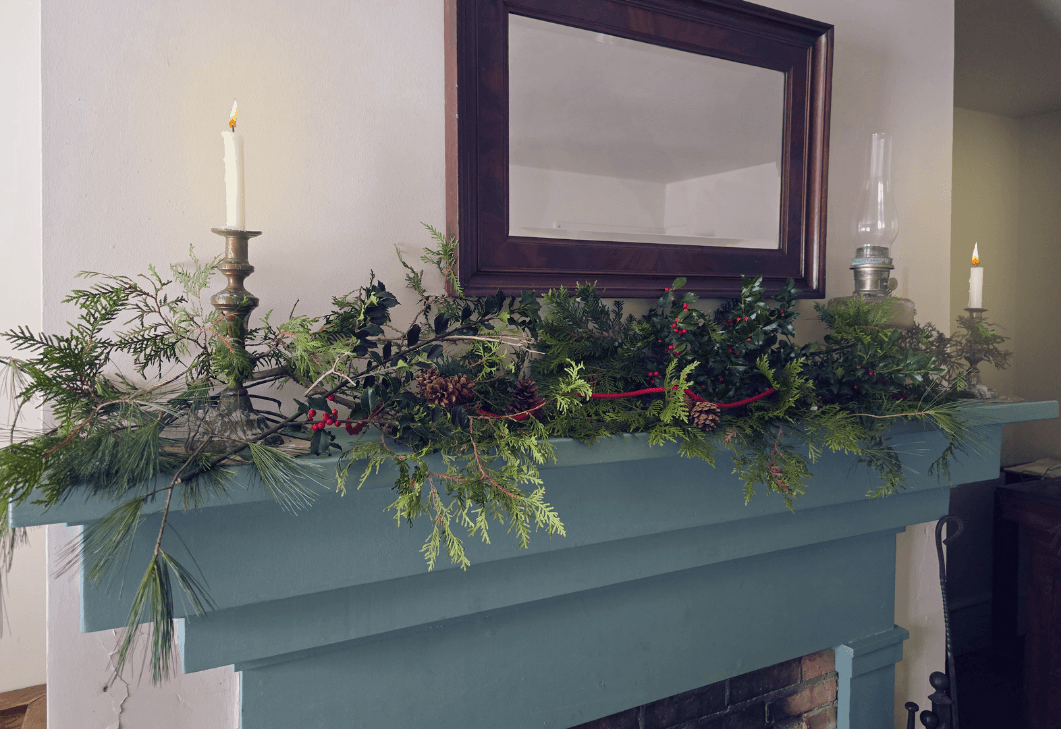 Bristol Inn mantel decorated with greenery and candles.
