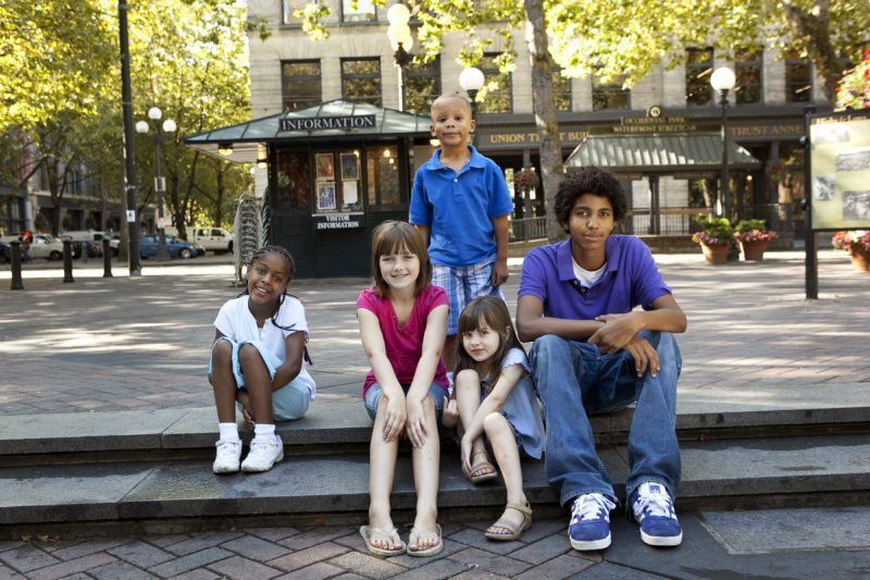 Group of kids sitting at a park