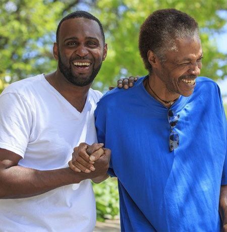 Two men smiling