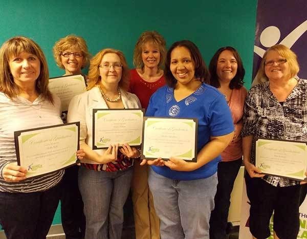 Women smiling with awards.