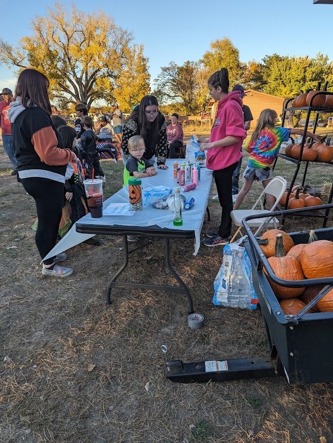 Pumpkin painting station at Bader's annual Halloween event