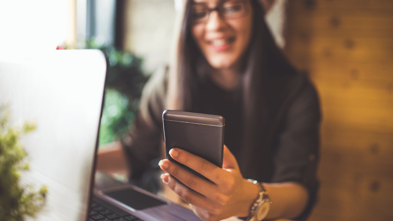 Young woman holding smart phone