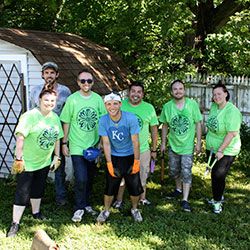 Planting Independence volunteers in bright green shirts