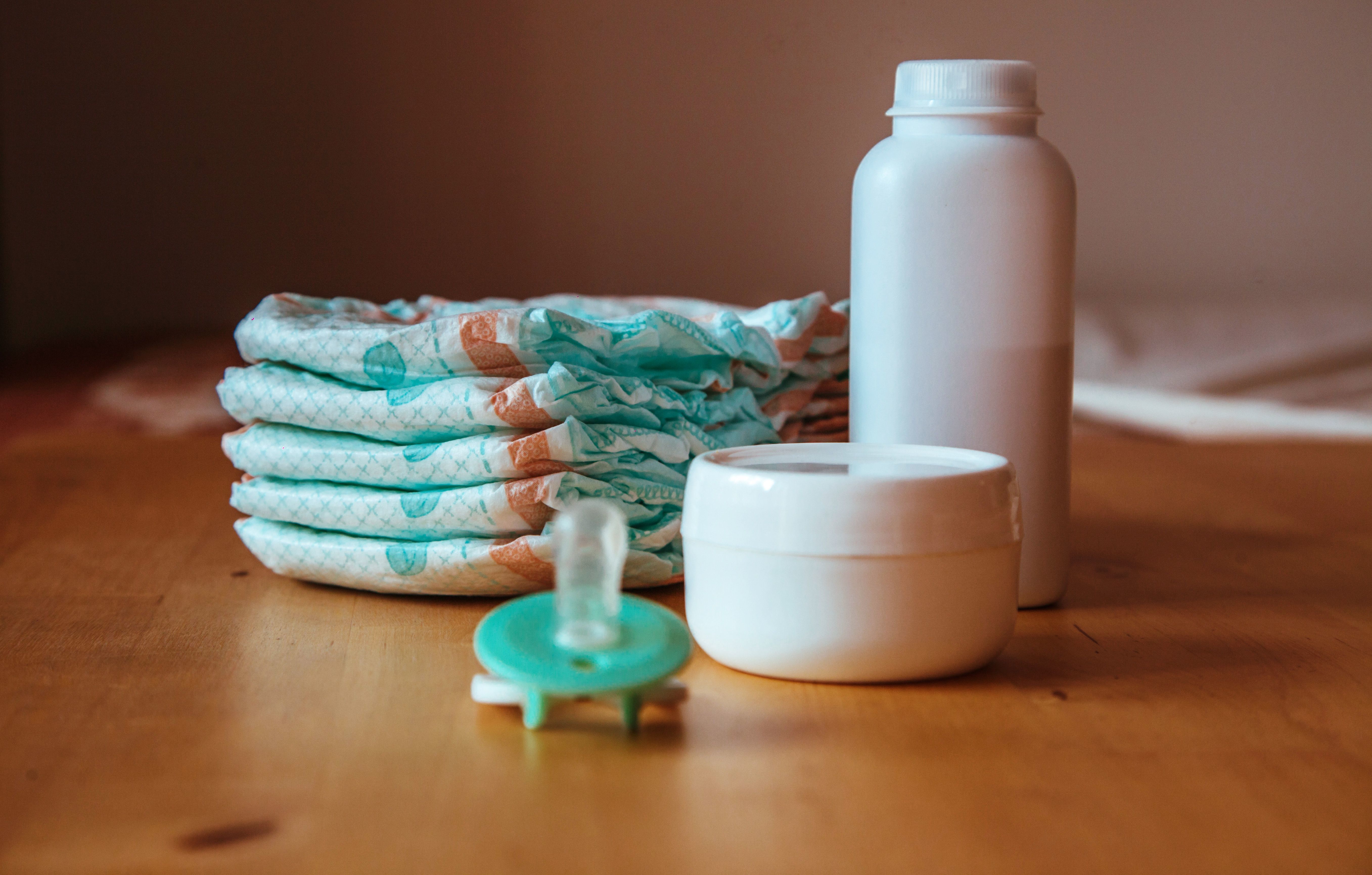 image of baby care products and stack of diapers