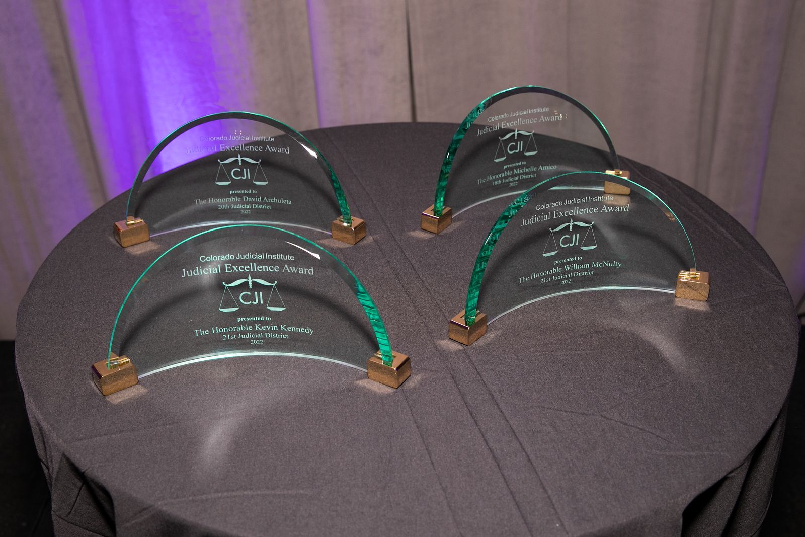 Several crystal awards for CJI's judicial excellence award winners are placed on a table