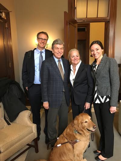 A photo of Mark Dunning, Moira Shea wth her guide dog Finnegan, and Krista Vasi with Senator Roy Blunt