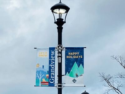 Two full-color vinyl pole banners printed for the City of Grandview, Missouri, hanging from a street lamp.