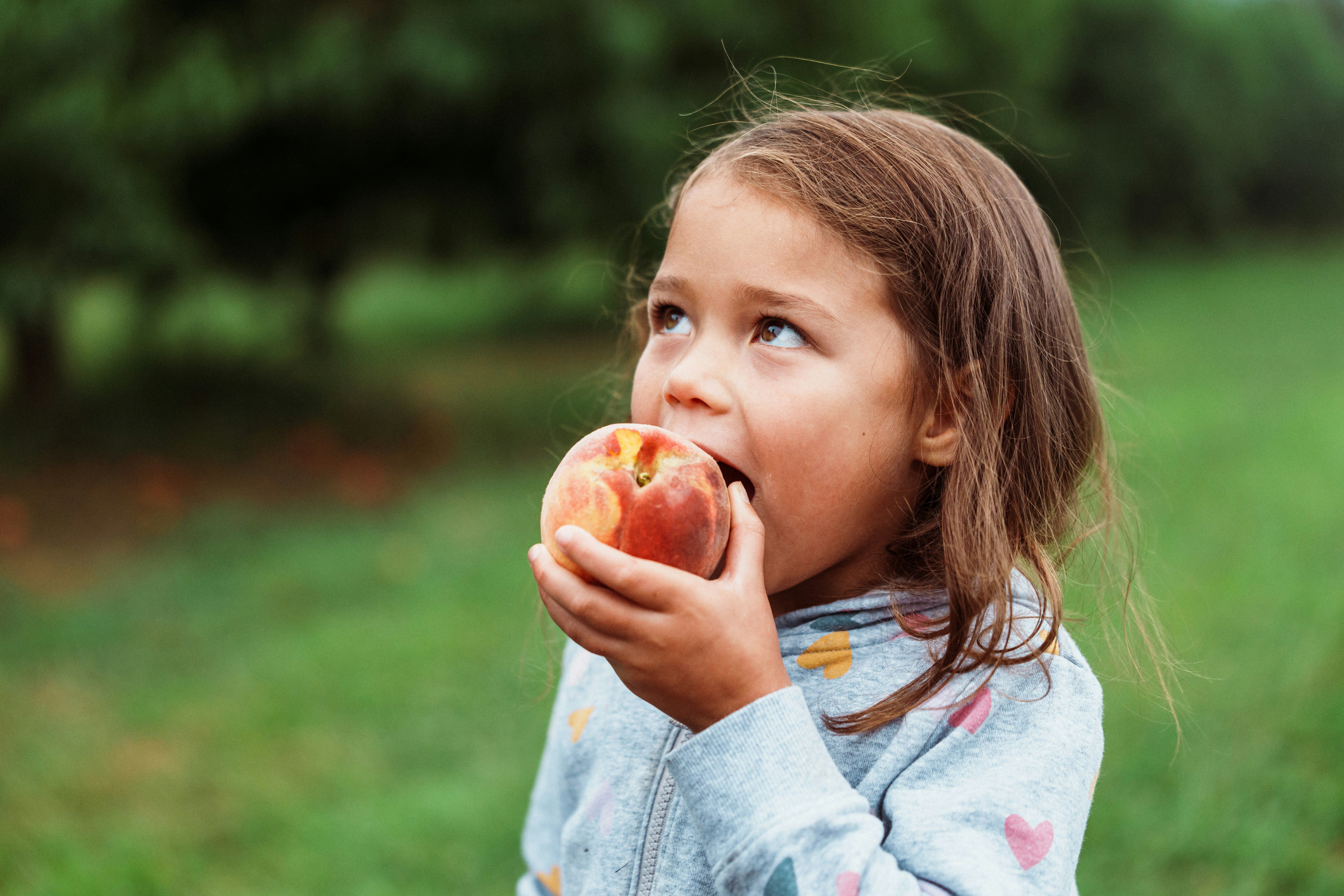 grandmother and young girl chopping vegetables
