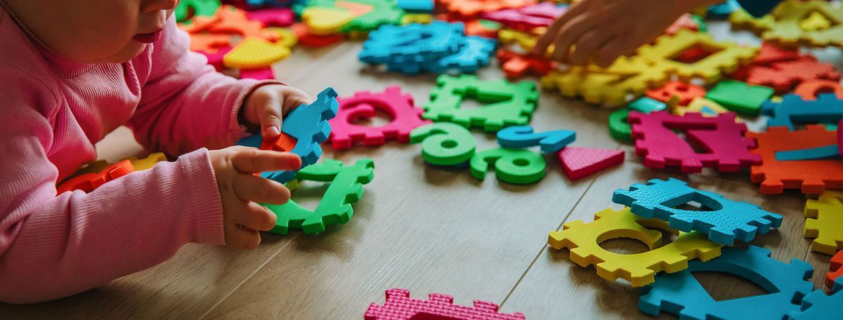 Child playing with foam letters and numbers