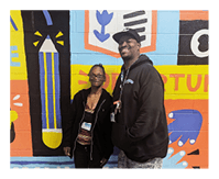 Ravon and Michelle in front of mural
